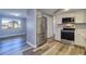 Well-lit kitchen featuring stainless steel appliances, and modern gray flooring at 3048 Holiday Lake Dr, Holiday, FL 34691