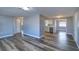 Open-concept living room with modern gray floors, with an open view to kitchen and hall at 3048 Holiday Lake Dr, Holiday, FL 34691