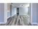 Open living space featuring gray wood floors, neutral walls, and arched doorway at 3048 Holiday Lake Dr, Holiday, FL 34691