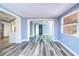 Bright living room boasts gray vinyl floors, light-blue walls, and open concept design at 3048 Holiday Lake Dr, Holiday, FL 34691