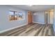 Bright living room with modern flooring, a window overlooking the neighborhood, and gray walls at 3048 Holiday Lake Dr, Holiday, FL 34691