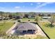 Aerial view of a new home construction on a spacious lot with lush greenery and open spaces at 31049 Eloian Dr, Wesley Chapel, FL 33545