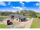 Exterior view of a new home's construction progress featuring a modern roof and window placements at 31049 Eloian Dr, Wesley Chapel, FL 33545
