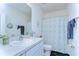 Clean bathroom with white vanity, patterned shower curtain, and tasteful nautical decor at 32960 Regent Canal St, Wesley Chapel, FL 33545