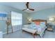Comfortable bedroom with tropical bedding, decorative ladder, wood ceiling fan, and light green walls at 32960 Regent Canal St, Wesley Chapel, FL 33545