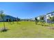 Community green space with lush green grass and small trees at 32960 Regent Canal St, Wesley Chapel, FL 33545