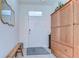 Bright foyer with a wooden bench, patterned rug, and natural light at 32960 Regent Canal St, Wesley Chapel, FL 33545