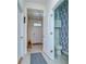Hallway view showcasing a stylish half bath with eye-catching wallpaper at 32960 Regent Canal St, Wesley Chapel, FL 33545