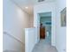 Bright hallway with carpet, leading to a bedroom with light green walls and tasteful decor at 32960 Regent Canal St, Wesley Chapel, FL 33545