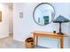 Hallway with a round mirror and decorative table at 32960 Regent Canal St, Wesley Chapel, FL 33545