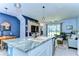 Open-concept kitchen flows into the living area, with stainless steel appliances and a granite island at 32960 Regent Canal St, Wesley Chapel, FL 33545
