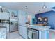 The kitchen features stainless steel appliances, granite counters, and an island with a sink and dishwasher at 32960 Regent Canal St, Wesley Chapel, FL 33545