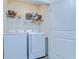 Bright laundry room featuring a Samsung washer and dryer and wire shelving at 32960 Regent Canal St, Wesley Chapel, FL 33545