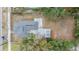 An aerial view of a home showing the roof, surrounding yard with mature trees, and a fenced perimeter at 3620 E Shadowlawn Ave, Tampa, FL 33610