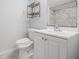 Bright bathroom features a toilet, vanity, and shower, with simple and functional design elements at 3620 E Shadowlawn Ave, Tampa, FL 33610