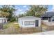 Charming single-story home with a well-maintained lawn and a picket fence at 3620 E Shadowlawn Ave, Tampa, FL 33610