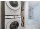 Convenient laundry area with stacked washer and dryer and storage at 3620 E Shadowlawn Ave, Tampa, FL 33610