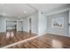 Bright and airy living room featuring sleek wood floors and freshly painted walls, seamlessly connecting to the kitchen at 3620 E Shadowlawn Ave, Tampa, FL 33610