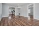 Spacious living room boasts pristine wood floors and fresh paint, with an open layout flowing into the bright kitchen at 3620 E Shadowlawn Ave, Tampa, FL 33610