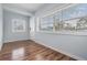 Inviting living room features stylish wood floors, natural light from large windows, and a fresh neutral paint palette at 3620 E Shadowlawn Ave, Tampa, FL 33610
