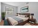 Well-lit main bedroom featuring a large window, modern decor, and warm wood accents at 3620 E Shadowlawn Ave, Tampa, FL 33610