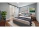 Modern main bedroom with ensuite bath featuring a sliding barn door and stylish decor at 3620 E Shadowlawn Ave, Tampa, FL 33610