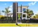 Stunning modern home with palm trees, black accents, and a bright green front door at 3633 S Renellie Dr, Tampa, FL 33629