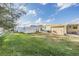 Spacious backyard with a white storage shed, fencing, and a covered patio at 36936 Kay Ave, Zephyrhills, FL 33542