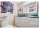 Bathroom featuring a toilet and a white vanity with drawers and cabinets at 36936 Kay Ave, Zephyrhills, FL 33542