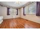 The spacious bedroom features hard wood floors and natural light at 36936 Kay Ave, Zephyrhills, FL 33542