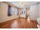 Bright bedroom features a ceiling fan, wood floors, and a dresser with a mirror at 36936 Kay Ave, Zephyrhills, FL 33542