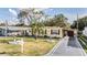 Charming yellow single-story home with red shutters, a driveway, and a mailbox at 36936 Kay Ave, Zephyrhills, FL 33542