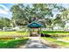 Scenic Kissing Bridge with blue trim nestled under lush trees in a serene community setting at 36936 Kay Ave, Zephyrhills, FL 33542