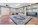 Bright living room features wood floors and sliding glass door at 36936 Kay Ave, Zephyrhills, FL 33542
