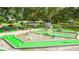 Well-maintained miniature golf course with landscaping and mature trees at 36936 Kay Ave, Zephyrhills, FL 33542