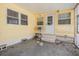 Covered patio with yellow siding, a white door, and access to the backyard at 36936 Kay Ave, Zephyrhills, FL 33542