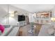 Inviting living room featuring an open layout, modern entertainment center, and seamless flow into the kitchen area at 406 W Azeele St # 103, Tampa, FL 33606