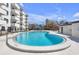 A spacious community pool is surrounded by clean white pavers at 406 W Azeele St # 103, Tampa, FL 33606