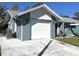 Exterior of home featuring an attached two car garage and a well-manicured yard at 4326 Great Lakes N Dr, Clearwater, FL 33762