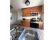 Traditional kitchen featuring stainless steel appliances and double bowl sink at 4326 Great Lakes N Dr, Clearwater, FL 33762