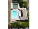Aerial view showcasing the community pool, shuffleboard courts, and surrounding amenities at 4355 Tahitian Gardens Cir # D, Holiday, FL 34691
