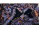 Night aerial view of a well-maintained community with winding roads, central lake, and illuminated homes at 4355 Tahitian Gardens Cir # D, Holiday, FL 34691