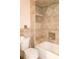 Bathroom with bathtub and tiled walls at 4355 Tahitian Gardens Cir # D, Holiday, FL 34691