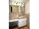 Bathroom vanity with large mirrors and sink at 4355 Tahitian Gardens Cir # D, Holiday, FL 34691