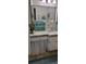 Nautical-themed bathroom features a vanity, decorated mirror, and unique beach-inspired decor at 4355 Tahitian Gardens Cir # D, Holiday, FL 34691
