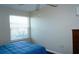 Bedroom with window and wood floors at 4355 Tahitian Gardens Cir # D, Holiday, FL 34691