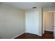Spacious bedroom with wood flooring, white closet, and access to another room at 4355 Tahitian Gardens Cir # D, Holiday, FL 34691