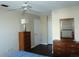 Bedroom with wood floors, dresser with mirror, and modern lamp at 4355 Tahitian Gardens Cir # D, Holiday, FL 34691