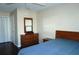 Bedroom with wood floors, dresser with mirror, and bed at 4355 Tahitian Gardens Cir # D, Holiday, FL 34691