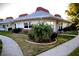 Well-maintained condo with landscaped yard, and a sidewalk leading to the entrance at 4355 Tahitian Gardens Cir # D, Holiday, FL 34691